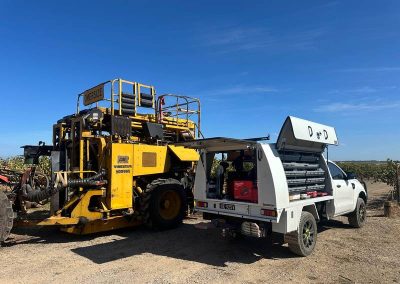 White truck with yellow heavy equipment vehicle